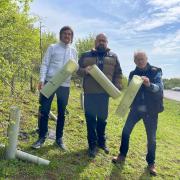 Graham Campbell and Ian Jackson, trustees of the Great Ouse Valley Trust, join Cllr Stephen Ferguson (centre) to highlight the issue of redundant tree guards along the A428.